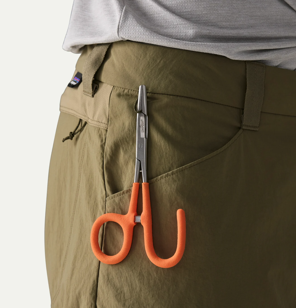 Hemostat hanging from tab on Patagonia Men's Sandy Cay Pants