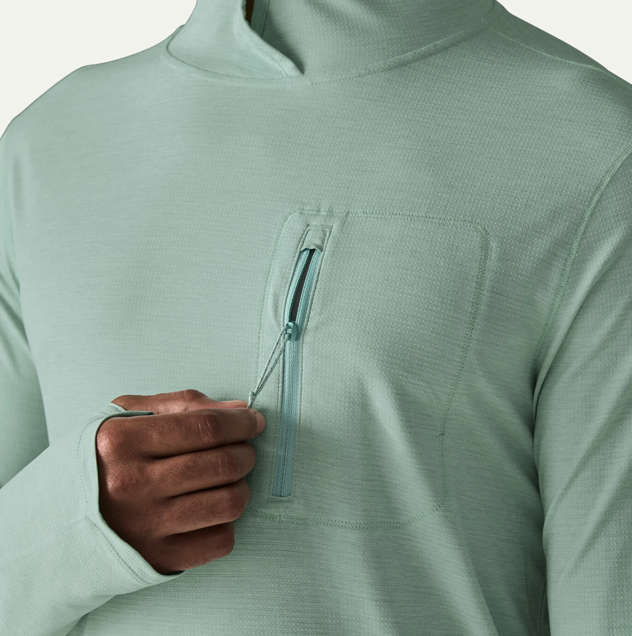 Chest pocket detail of Patagonia Capilene Cool Sun Hoody TBIX color