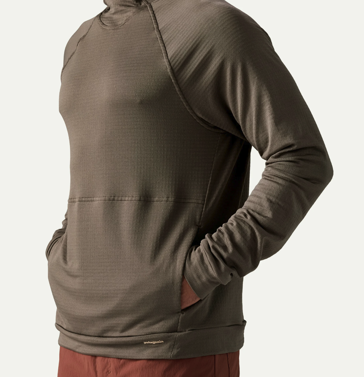 Model with hands in pockets of Patagonia Capilene Thermal Hoody