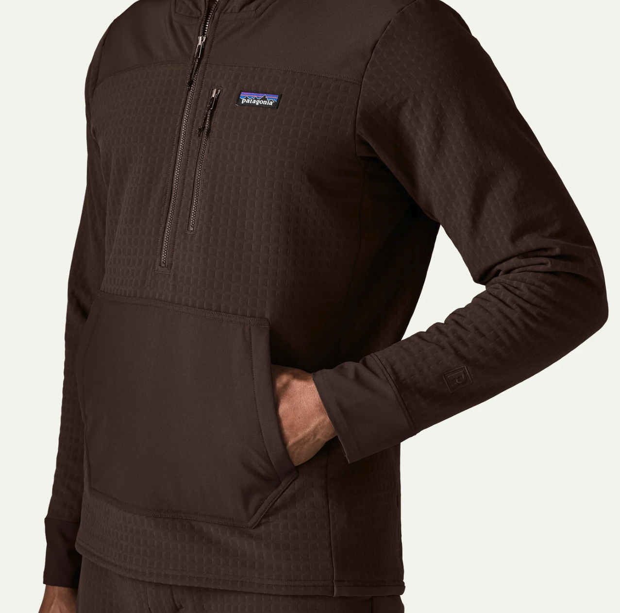 Close-up of Patagonia R2 TechFace fishing fleece showing zippered fly box chest pocket and kangaroo handwarmer pocket