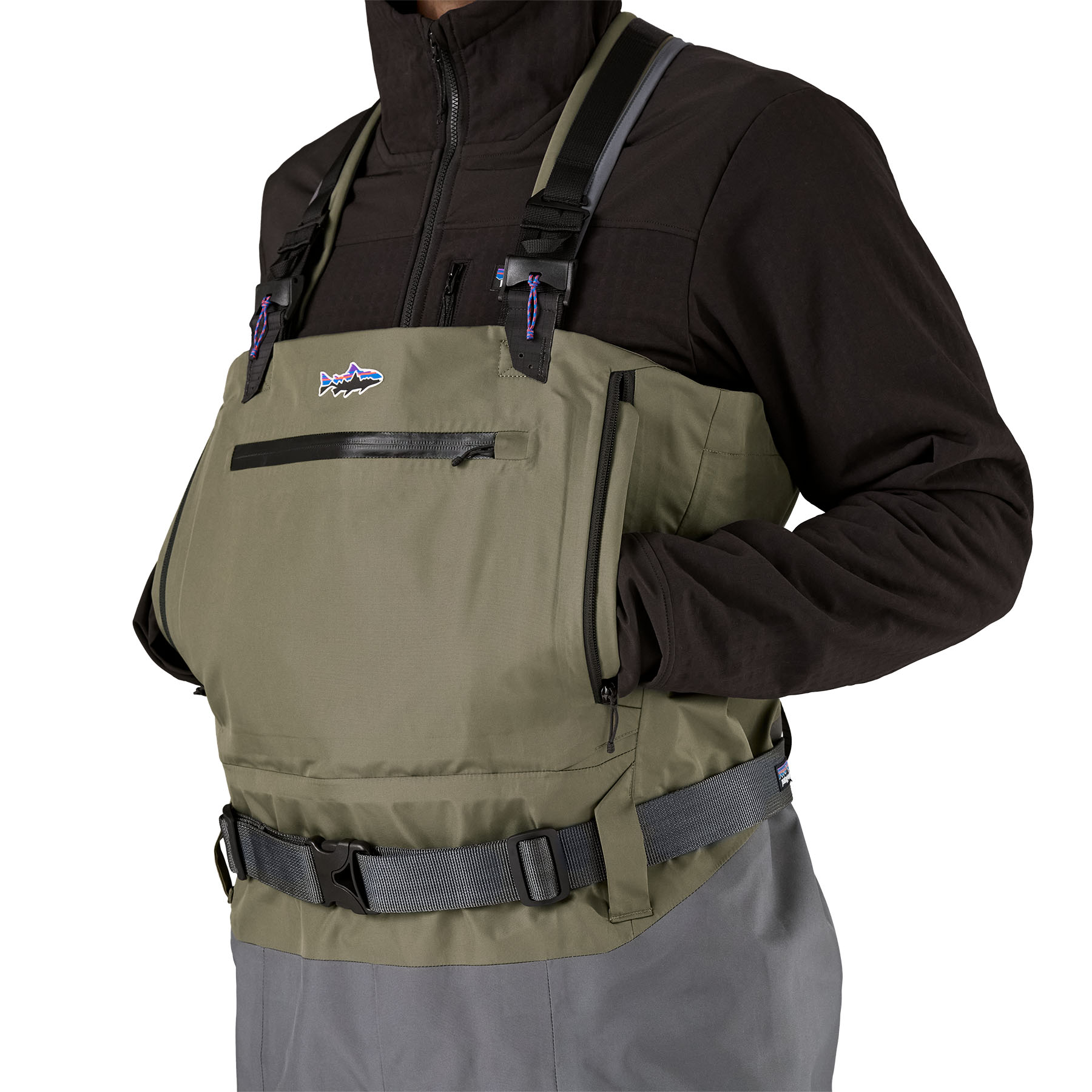 Model highlighting the large pass through fleece lined hand pockets on Patagonia's Swiftcurrent Expedition Wader