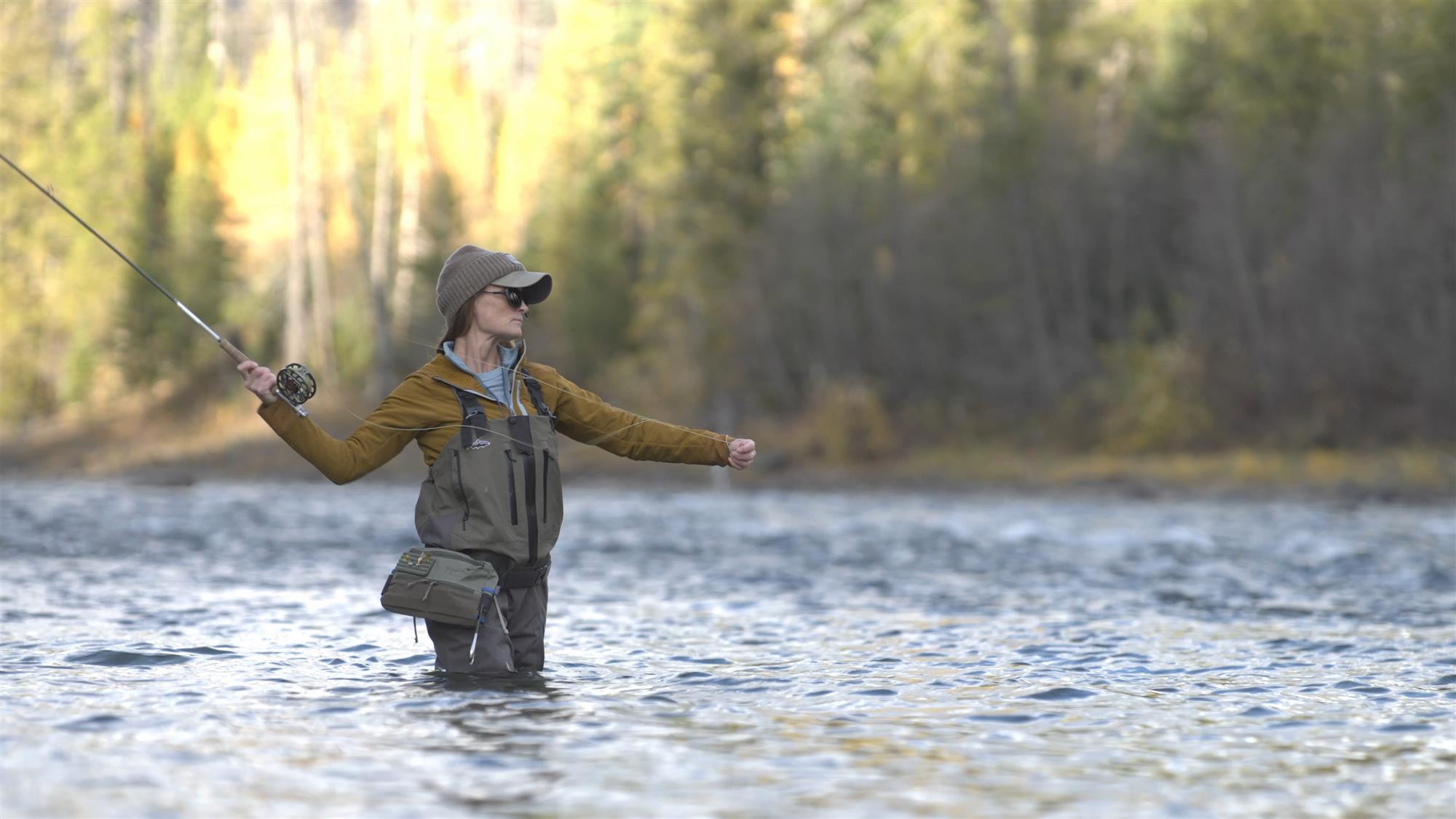 Female angler using the Patagonia Women's Swiftcurrent Expedition Zip-Front Waders