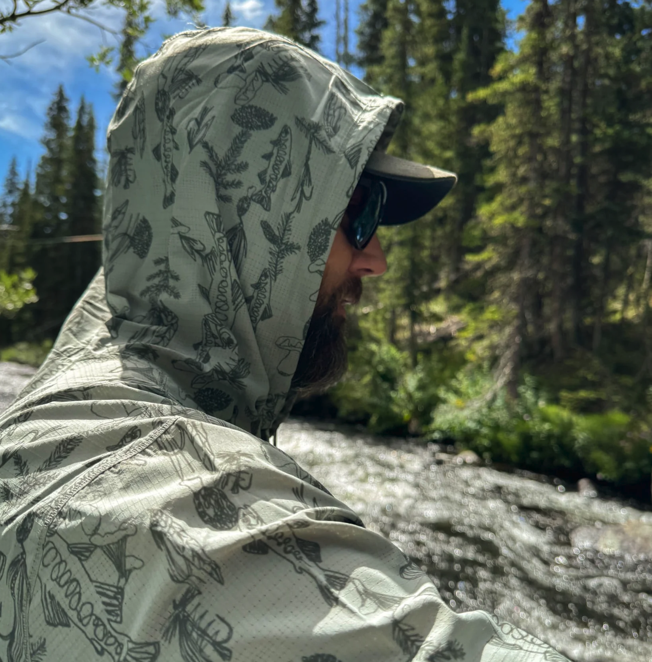 Angler with hood up wearing  Rep Your Water Flolite Sun Hoody Spring Forest color