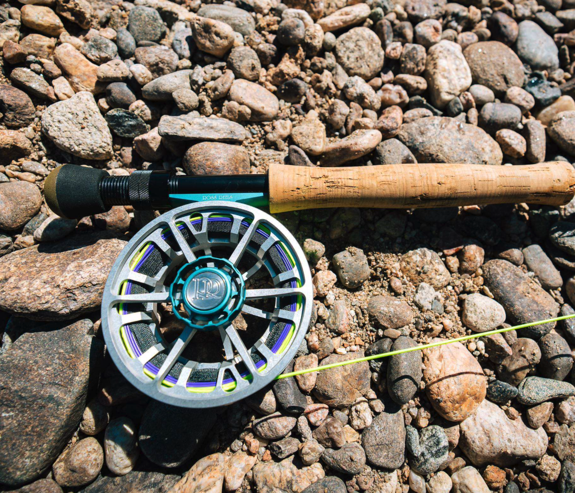 Ross Reels Evolution LTX Machinist Edition Fly Reel with rod on river bank rocks