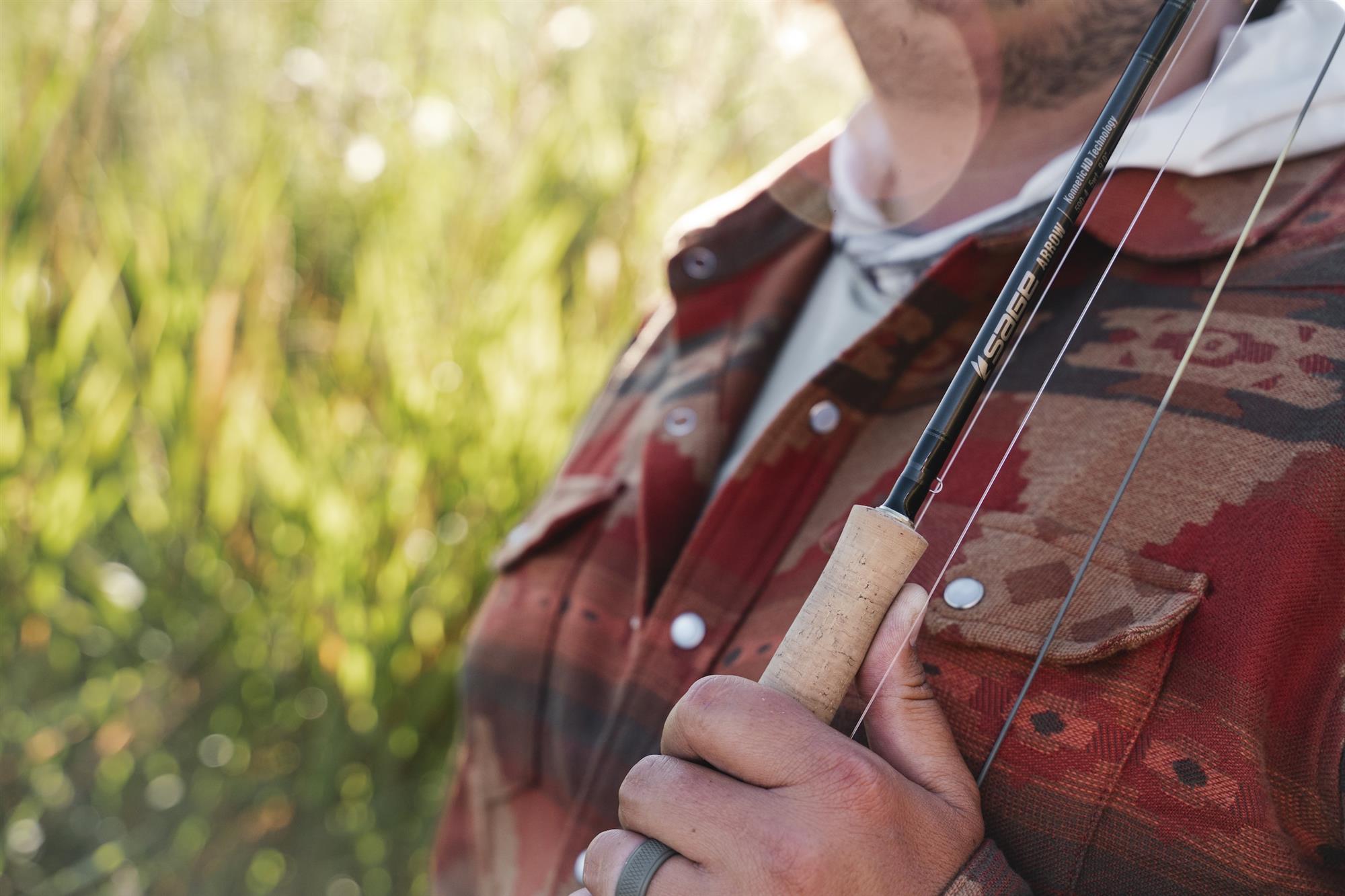 Angler holding Sage ARROW Fly Rod against shoulder