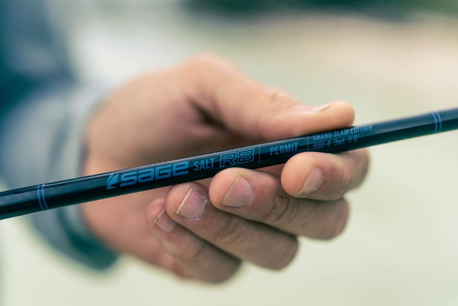 Angler holding label view of Sage SALT R8 Fly Rod Limited Edition Permit Grand Slam 990-4