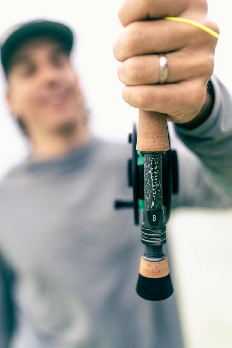 Angler holding up Sage SALT R8 Fly Rod Limited Edition Bonefish Grand Slam 890-4