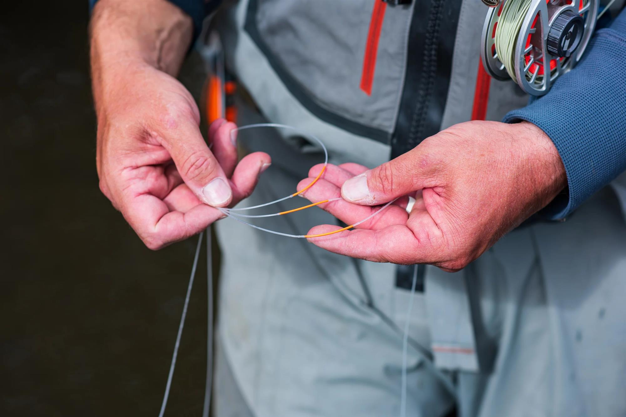 Angler using RestorLine LineSIGHT fly line indicators as visible distance markers for fly fishing line control