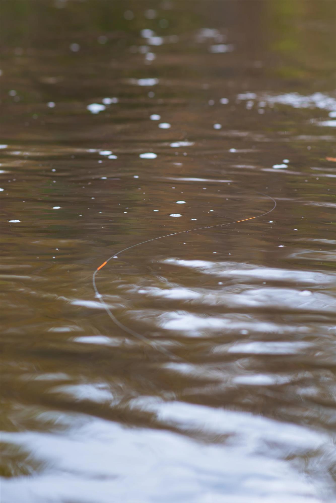 RestorLine LineSIGHT orange fly line indicators visible on the water for tracking line position and presentation