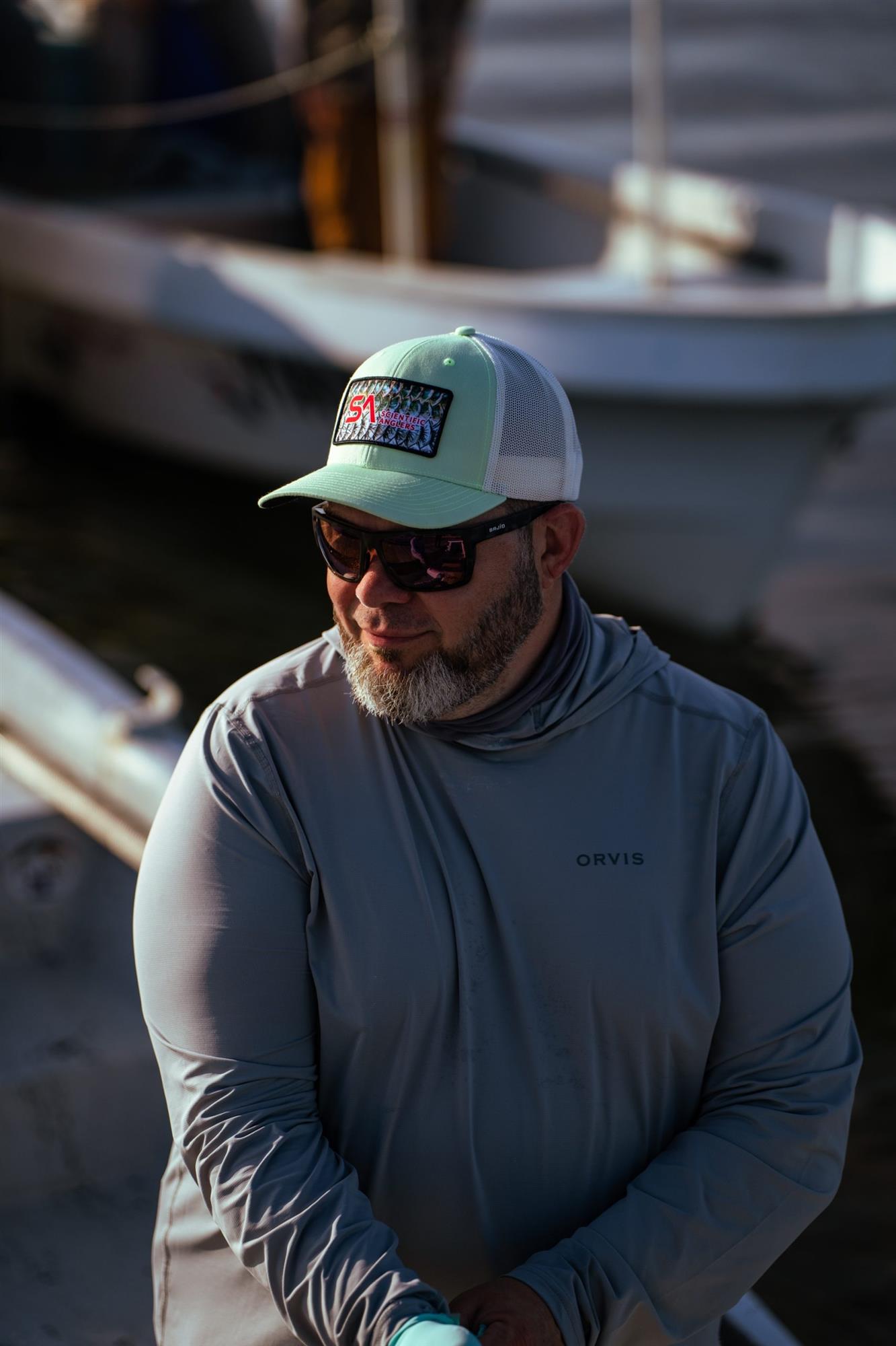 Scientific Anglers Tarpon Scale Trucker Hat worn by angler for saltwater fly fishing and outdoor use