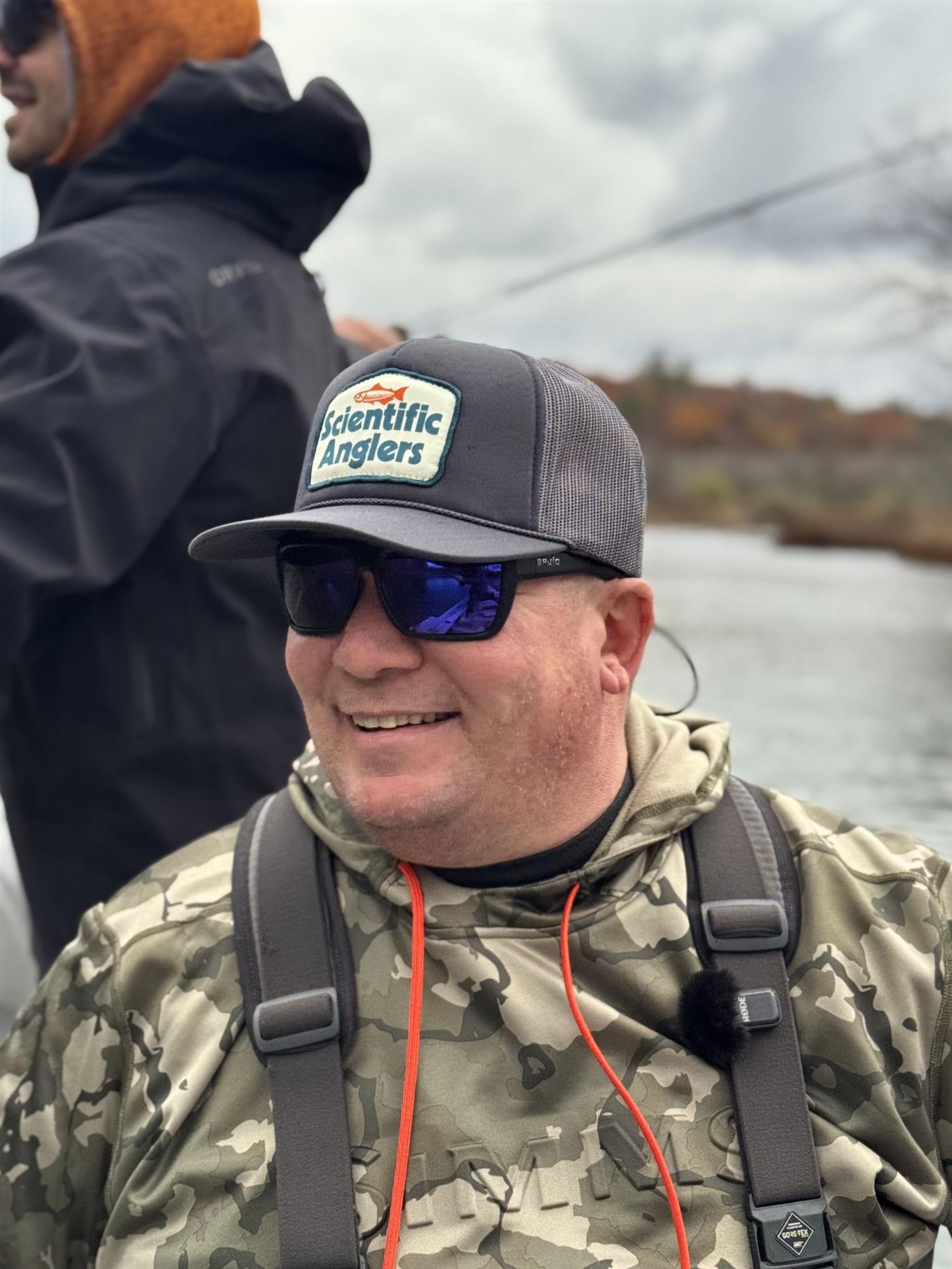 Scientific Anglers Foam Front Trucker Hat worn by angler outdoors while fly fishing