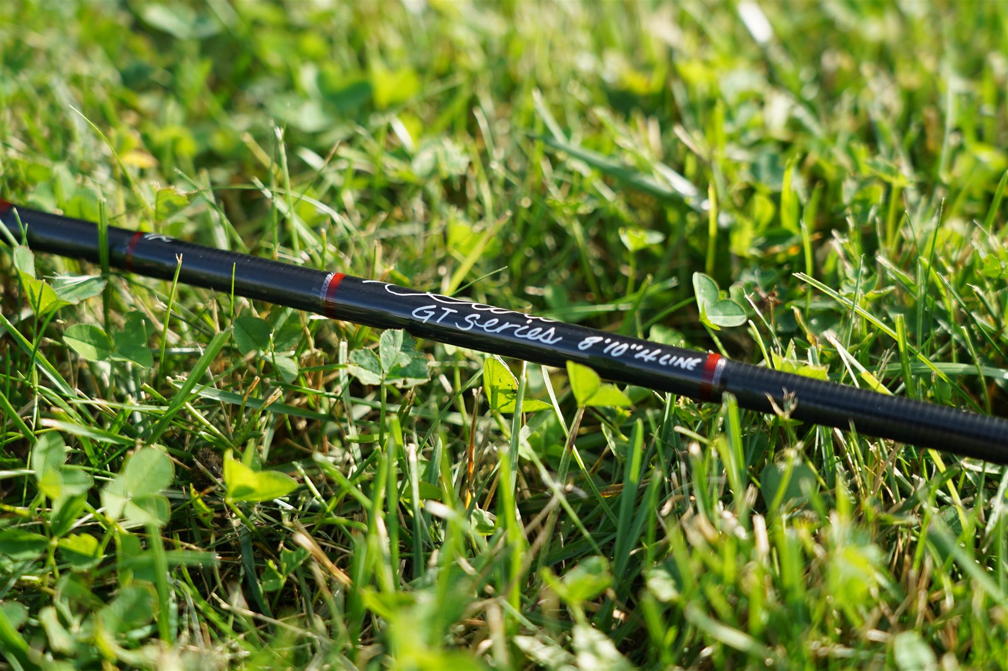 Handle detail of Scott GT Fly Rod laying in grass