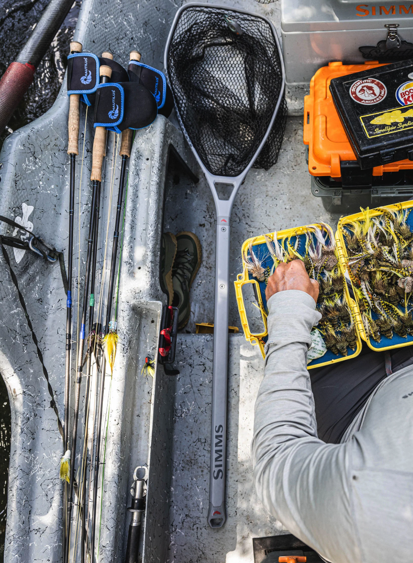 Simms Daymaker Boat Net Long Handle  laying in drift boat.