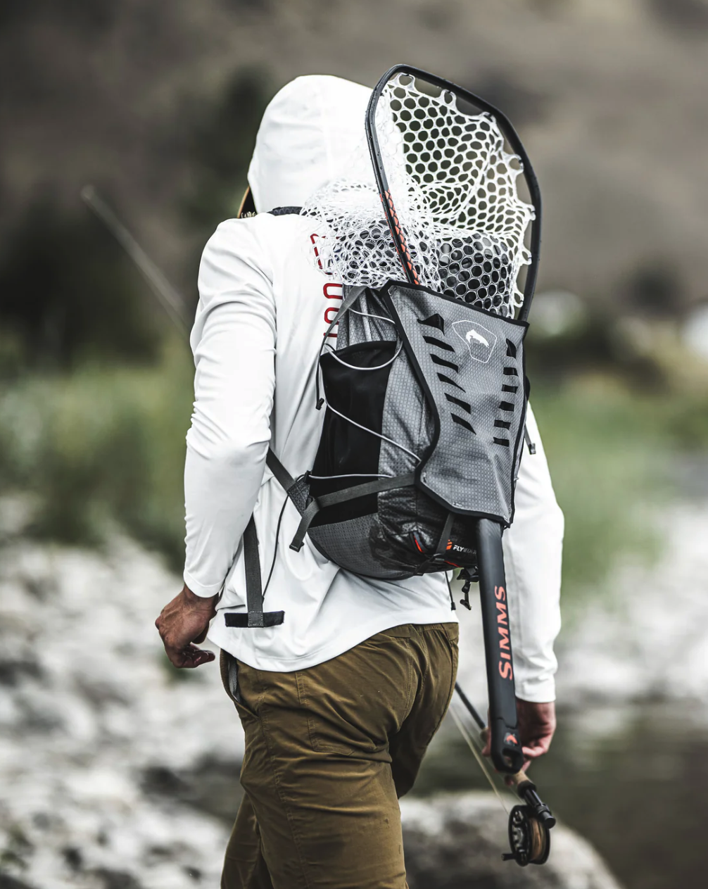 Ultimate outdoor companion: Simms Flyweight Backpack for versatile storage.