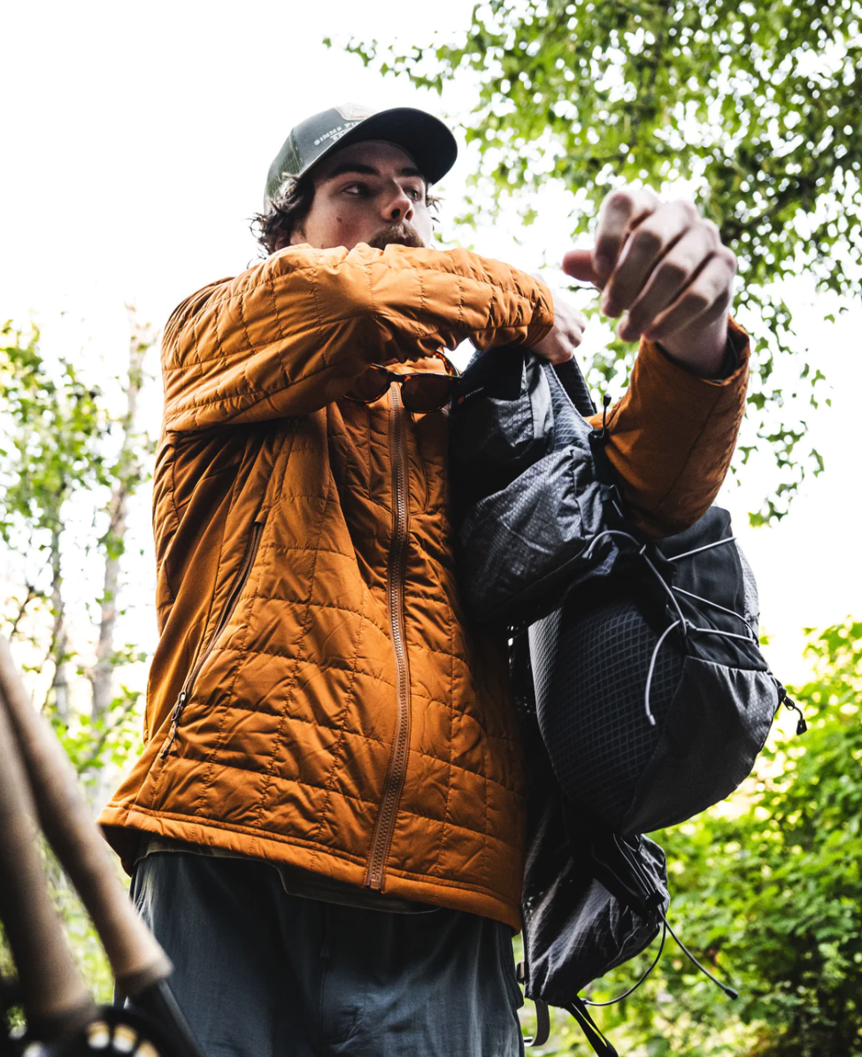 Durable Simms fishing vest pack with hydration bladder compatibility