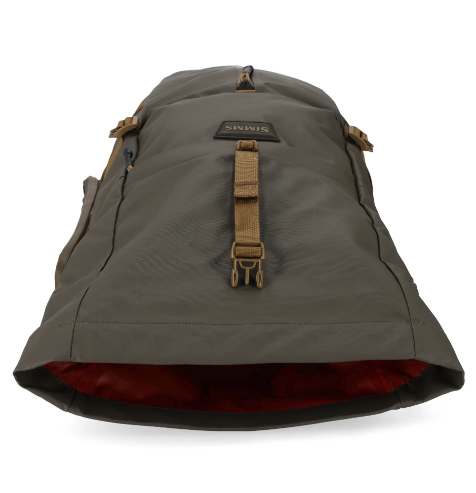 Simms Headwaters Backpack laying flat with top open.