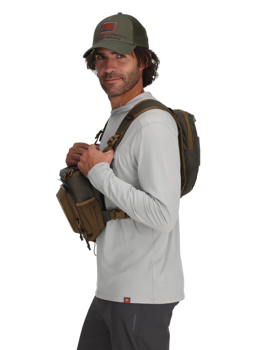 Side view of model wearing Simms Headwaters Chest Pack