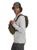 Side view of model wearing Simms Headwaters Chest Pack