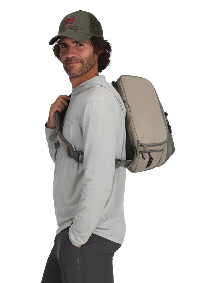 Side view of model wearing Simms Headwaters Sling Pack Dolomite color