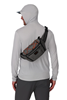 Model wearing sling Simms Scout Hip Pack