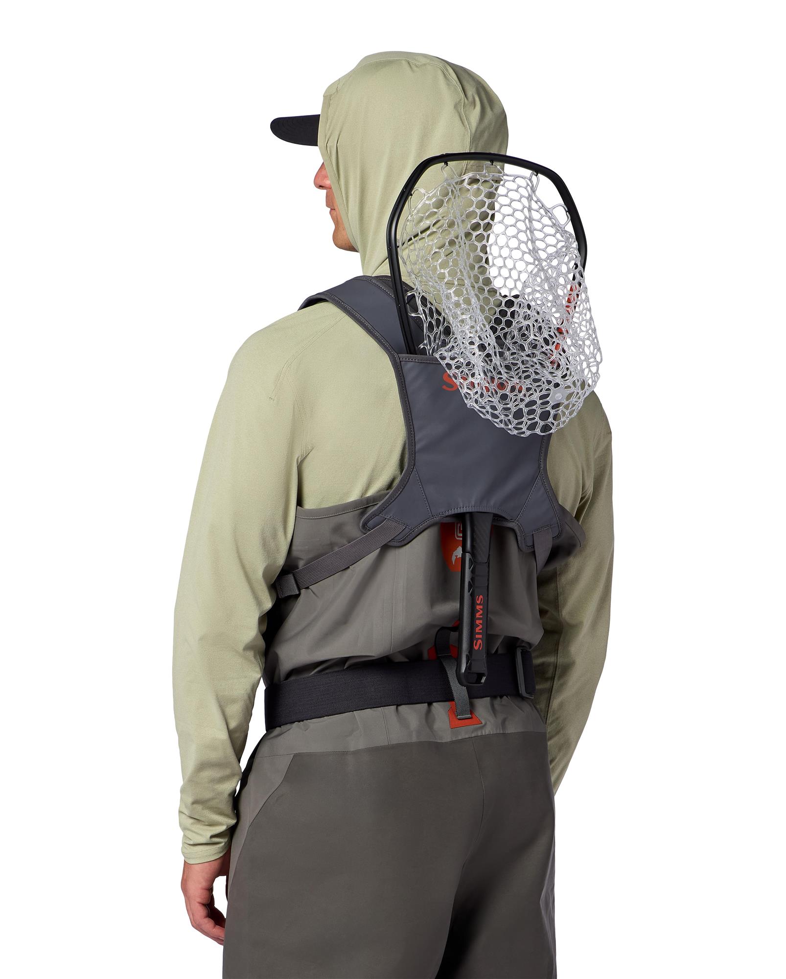 Simms Tributary Chest Pack worn with integrated rear net holder while fly fishing in waders with net