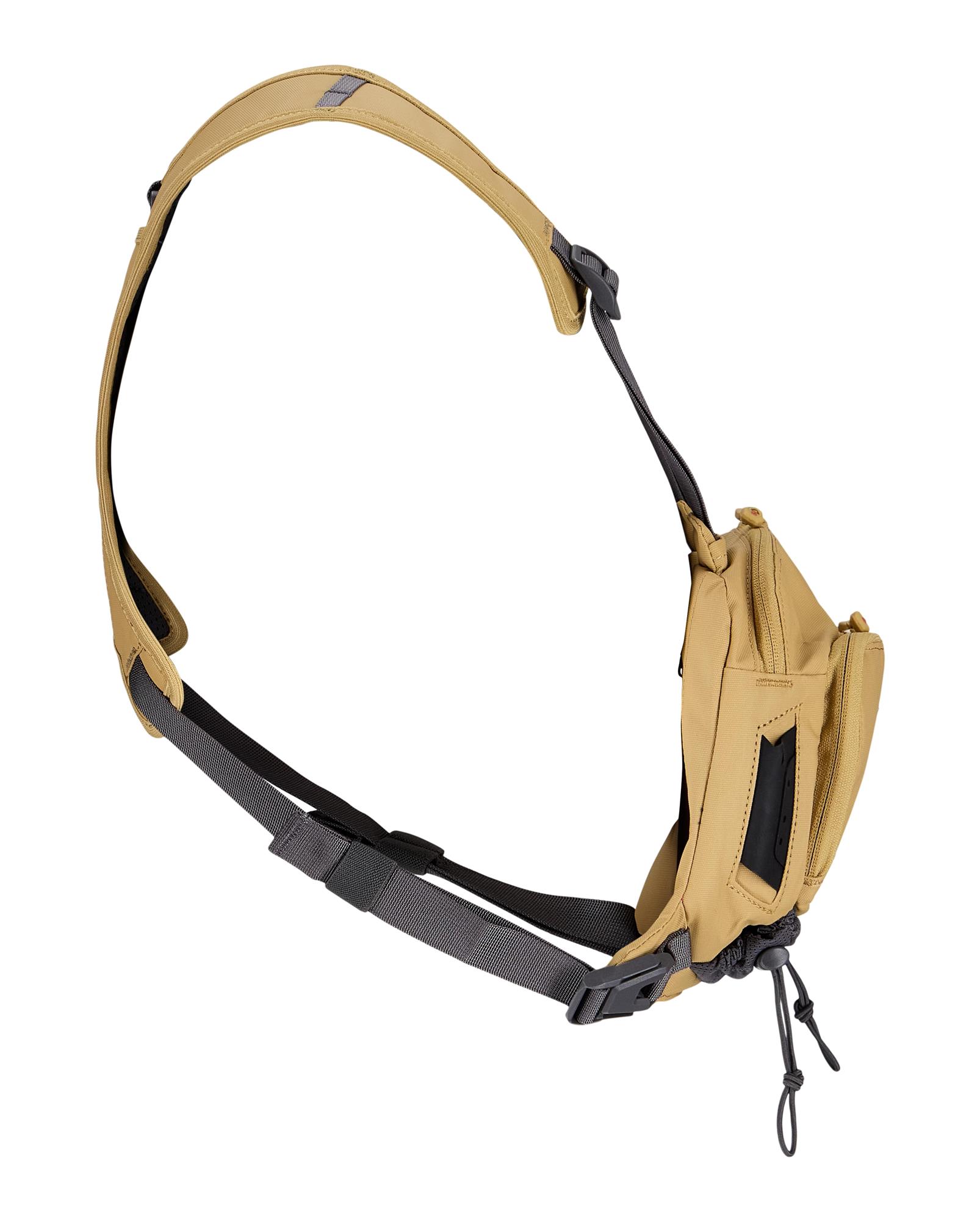 Side profile of Simms Tributary Chest Pack highlighting slim design and adjustable harness