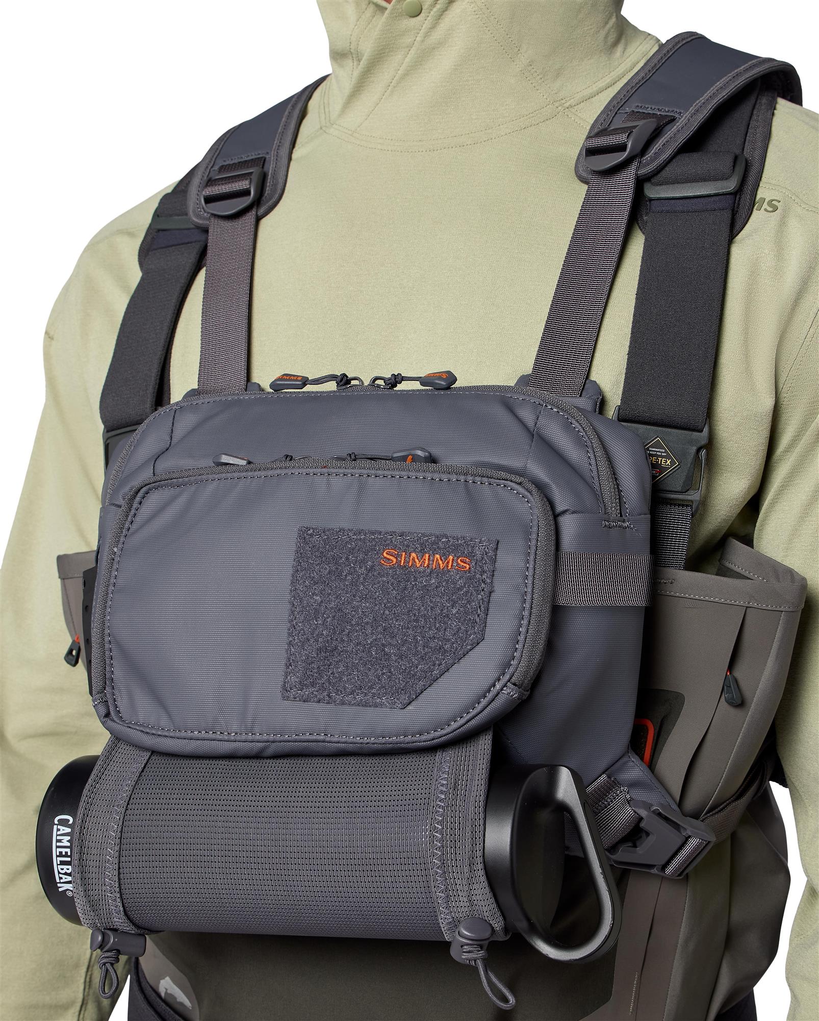 Close-up of Simms Tributary Chest Pack worn on chest with accessory attachment points