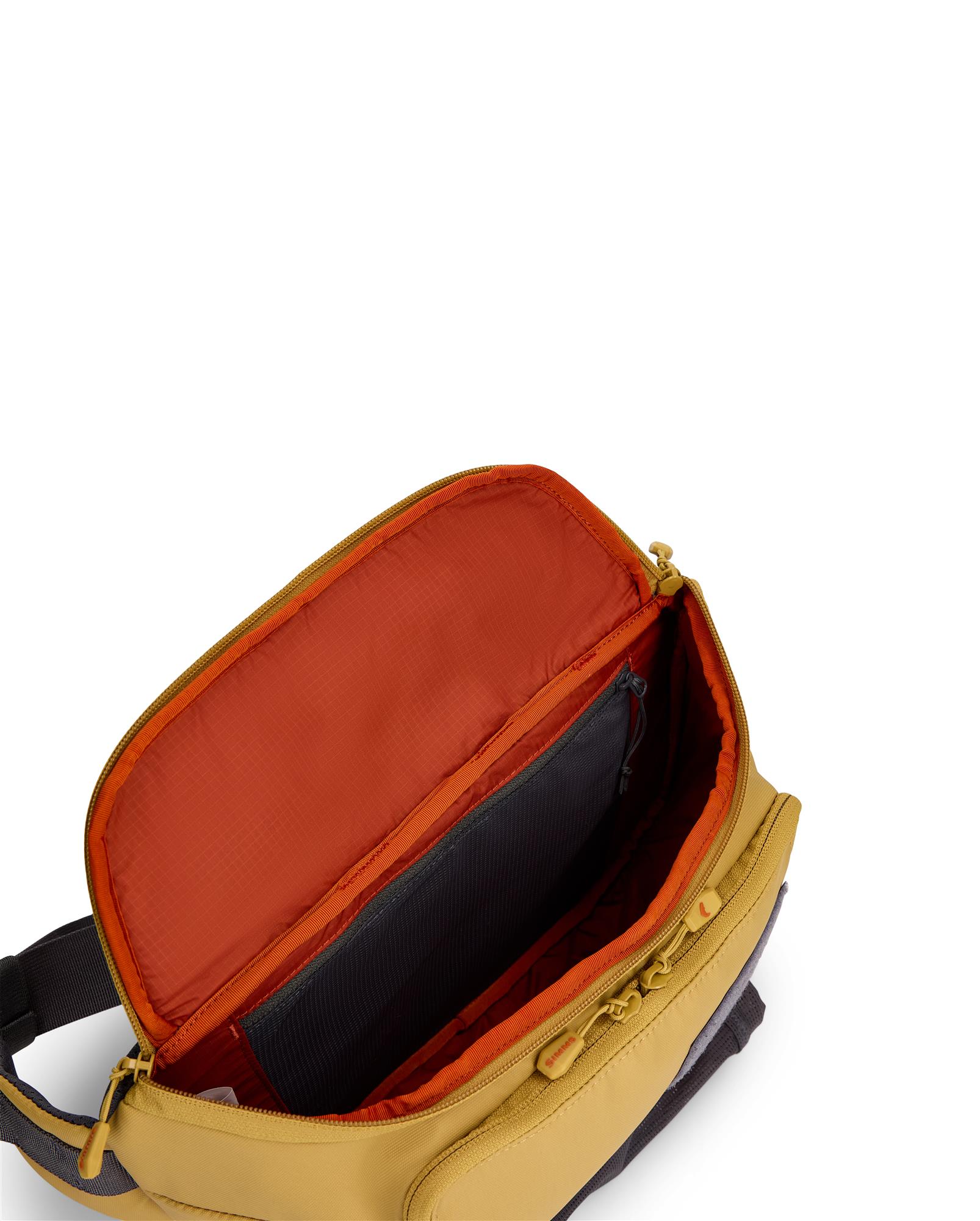 Simms Tributary Hip Pack main compartment open showing large capacity storage and mesh pocket