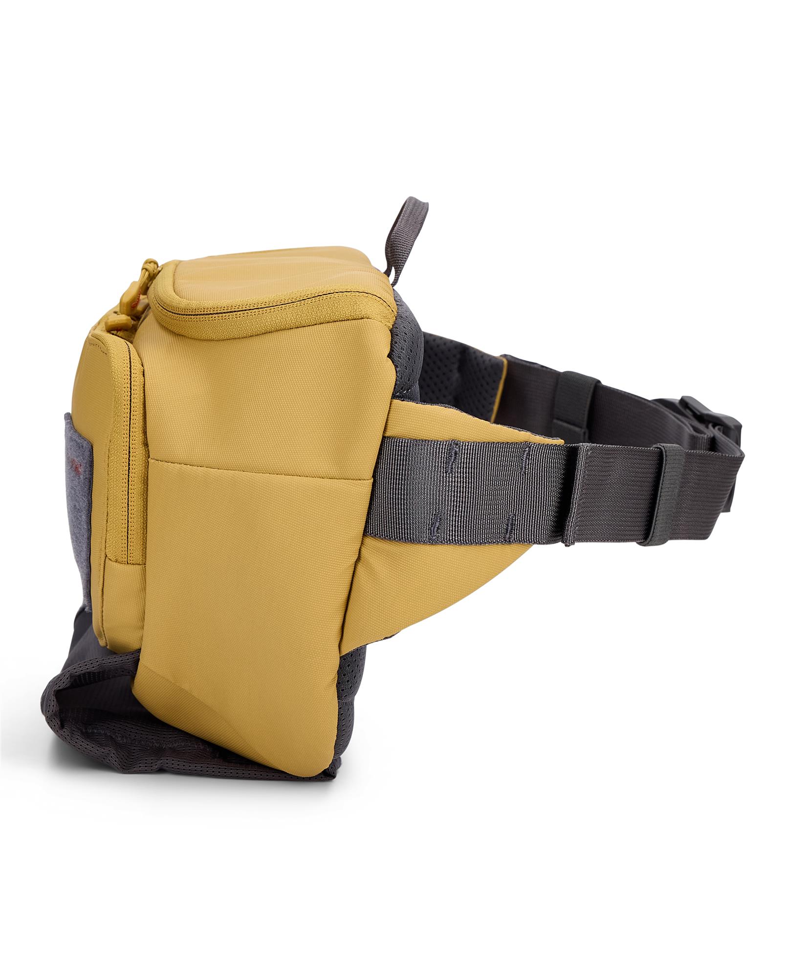Side profile of Simms Tributary Hip Pack with padded lumbar panel and adjustable waist belt