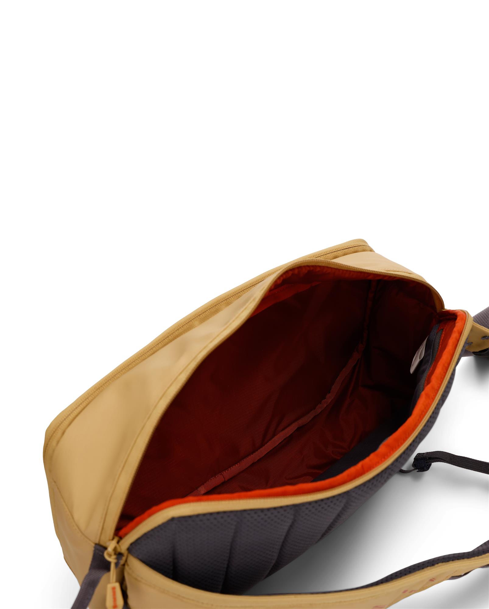 Simms Tributary Sling Pack main compartment open showing large capacity fly fishing gear storage