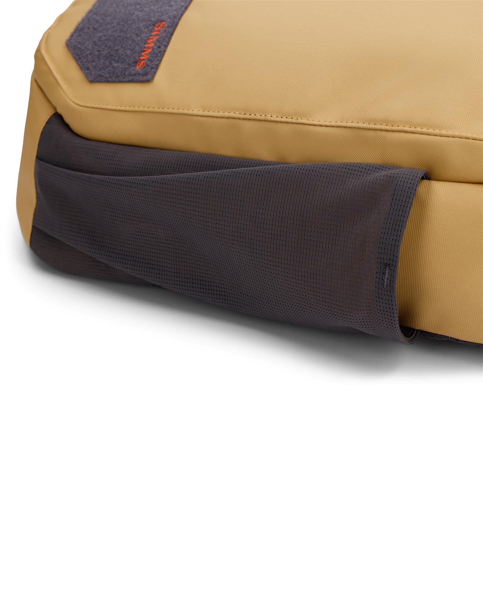Close-up of Simms Tributary Sling Pack underside stretch mesh pocket for water bottle or jacket