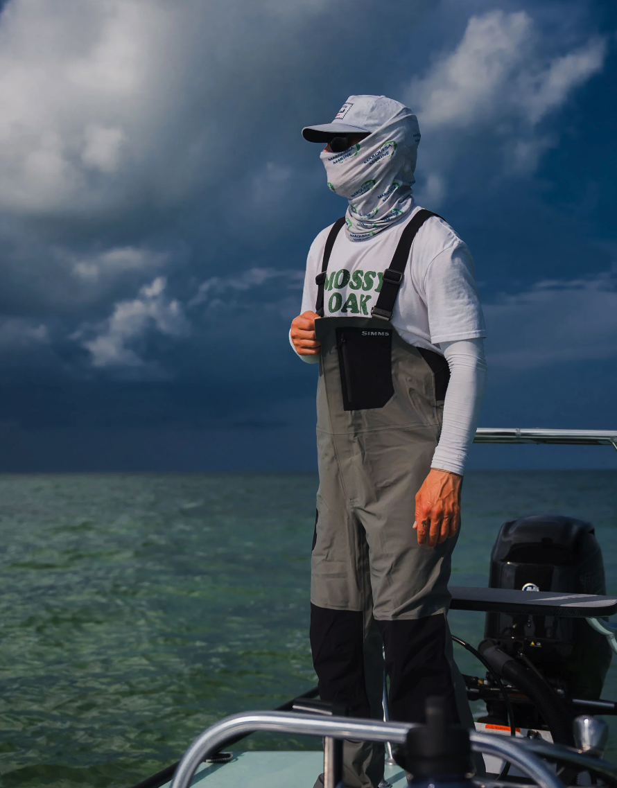 Angler wearing Simms Vapor Elite Bibs scanning water