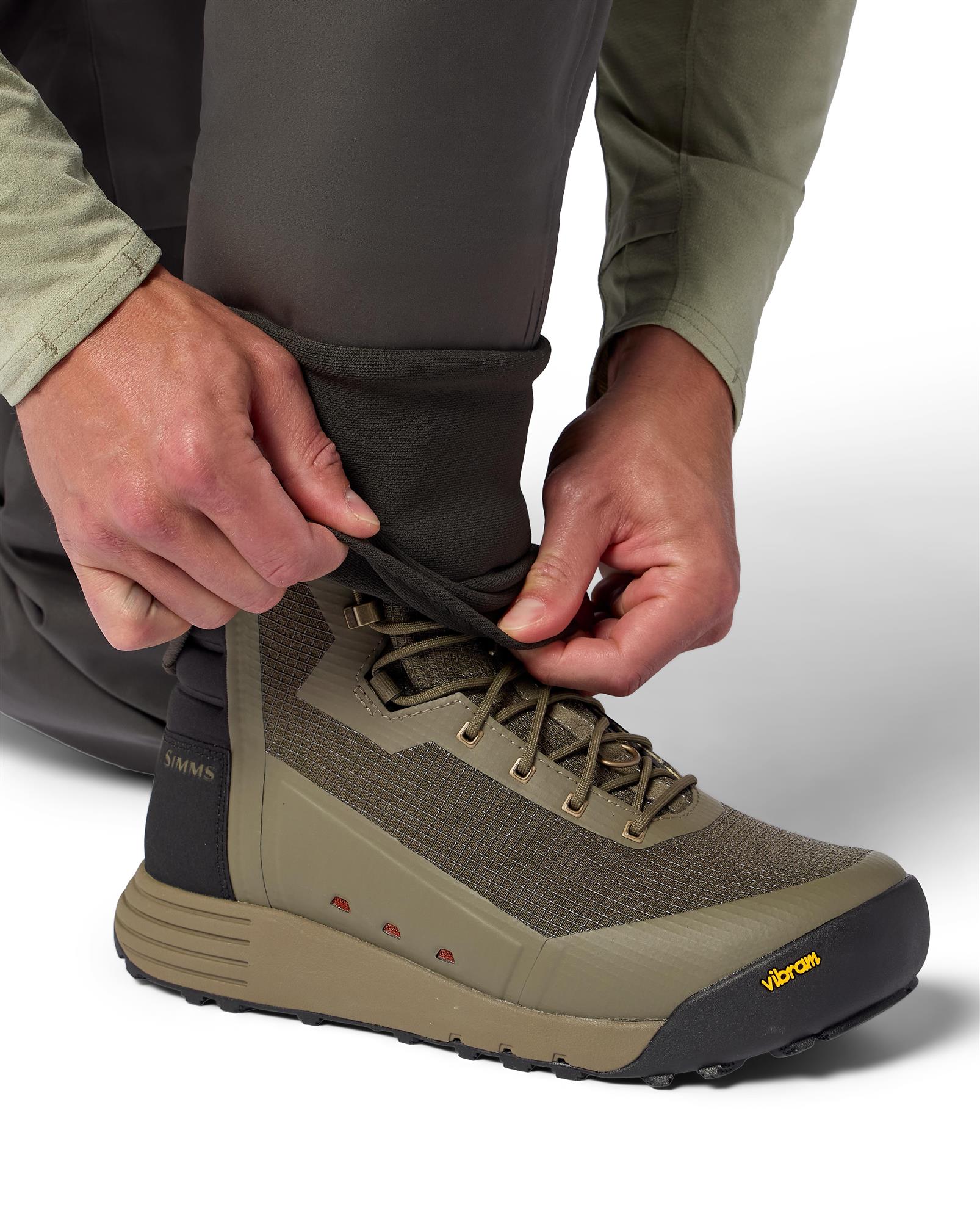 Close-up of Simms Access Wading Boot fit with waders, showing lightweight construction and comfort