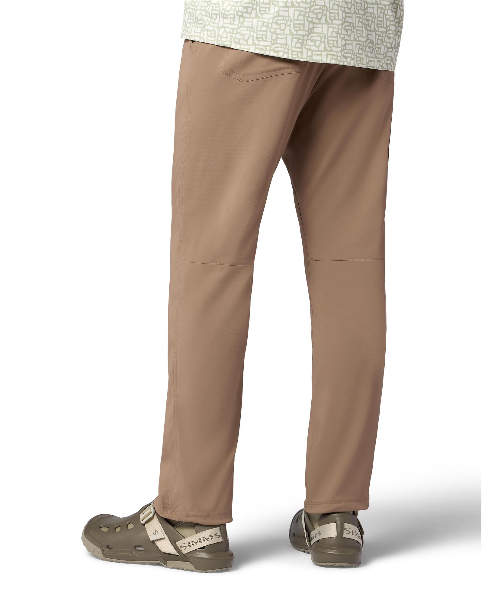 Rear lifestyle view of Simms Drifter AT wet wading shoes worn with fishing pants for river and boat fishing