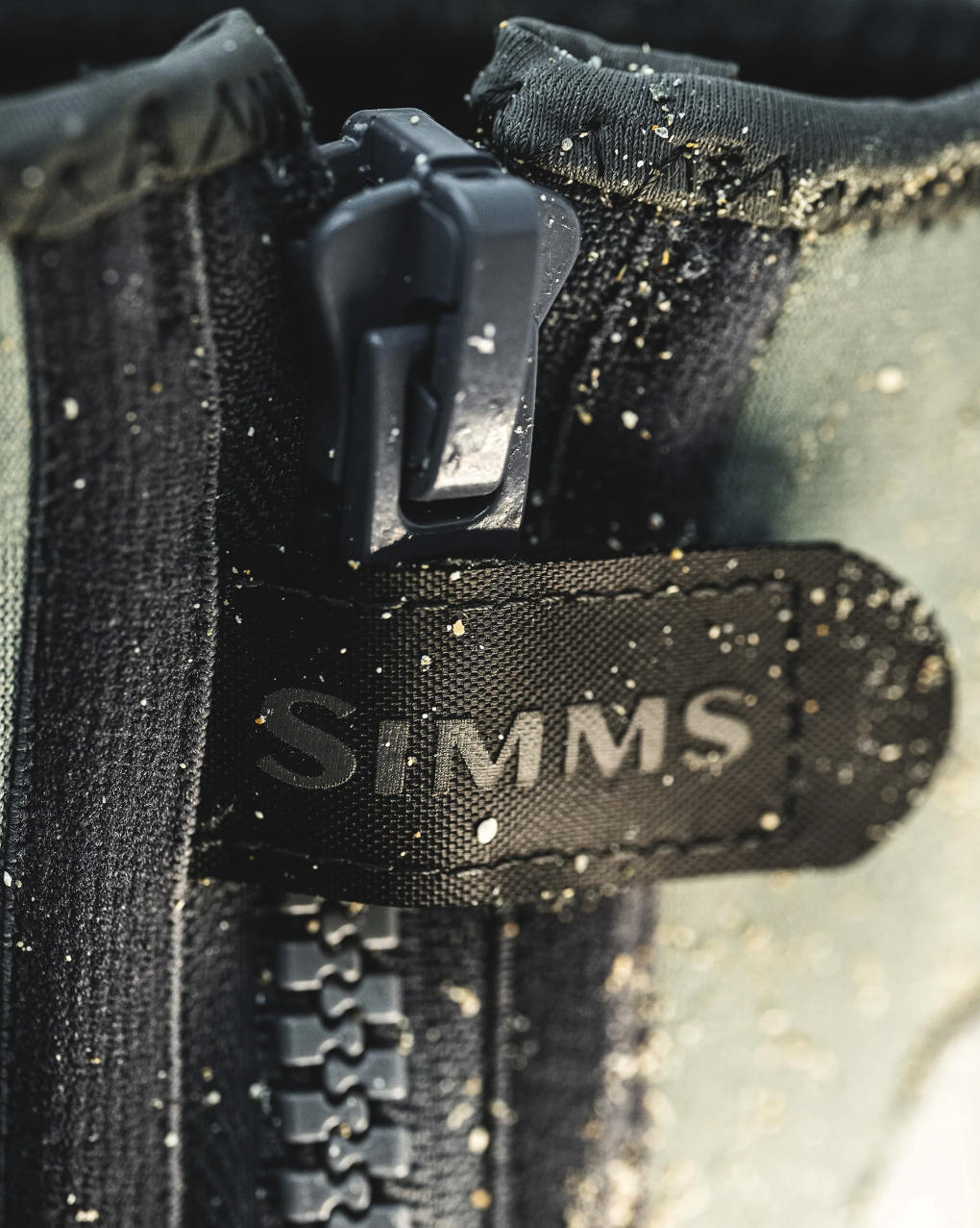 Simms ZipIt Flats Booties with a secure zip closure, providing easy on-and-off access for active fly fishermen.
