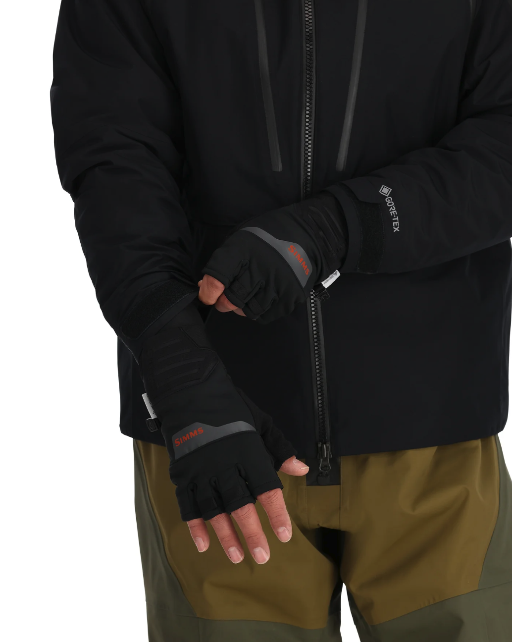 Model putting on Simms Windstopper Half-Finger Fishing Glove