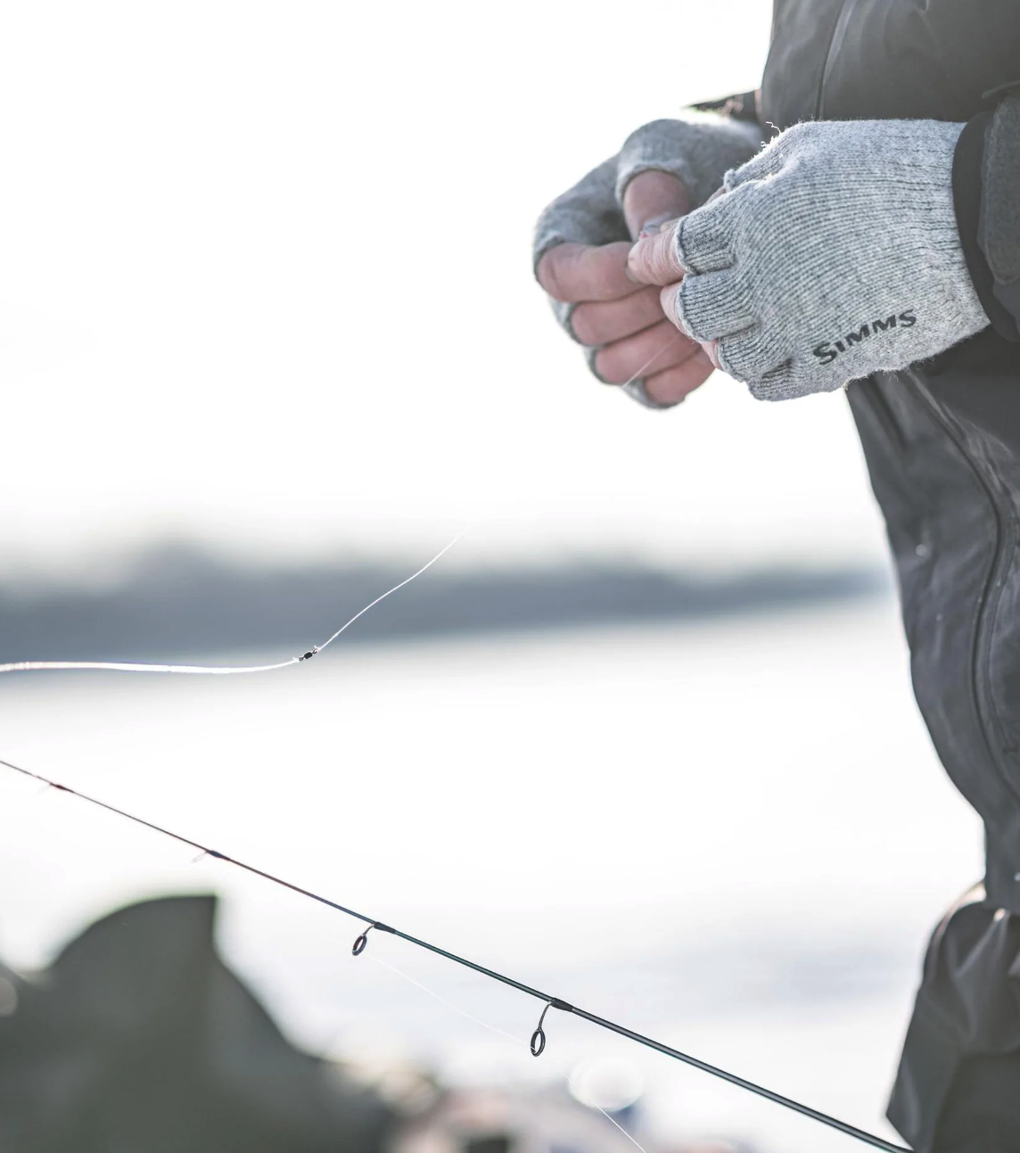 Simms outdoor fishing gloves with half-finger design for improved grip and precision.