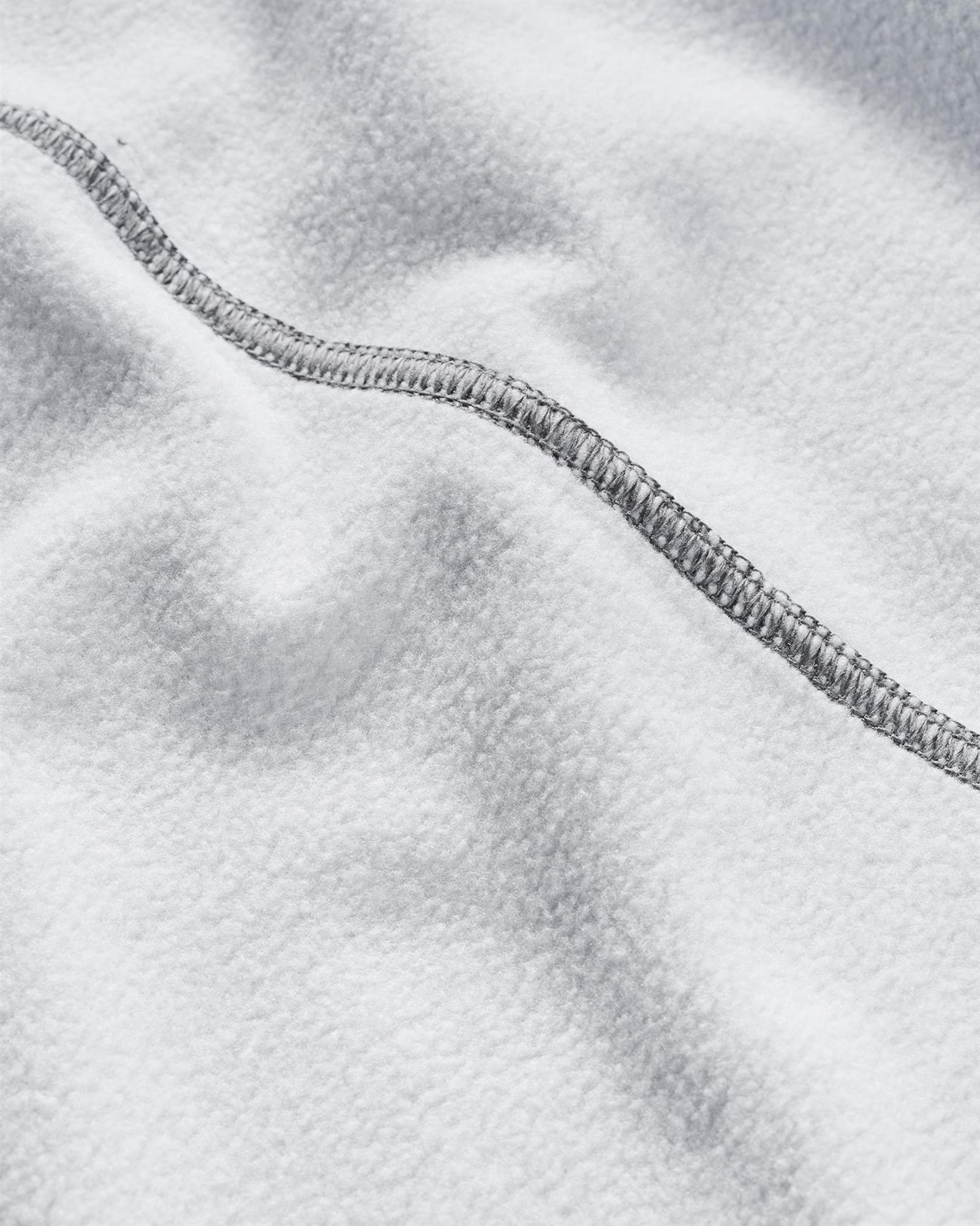 Brushed fleece interior of the Simms Challenger camping hoodie with a close-up of the stitched seam