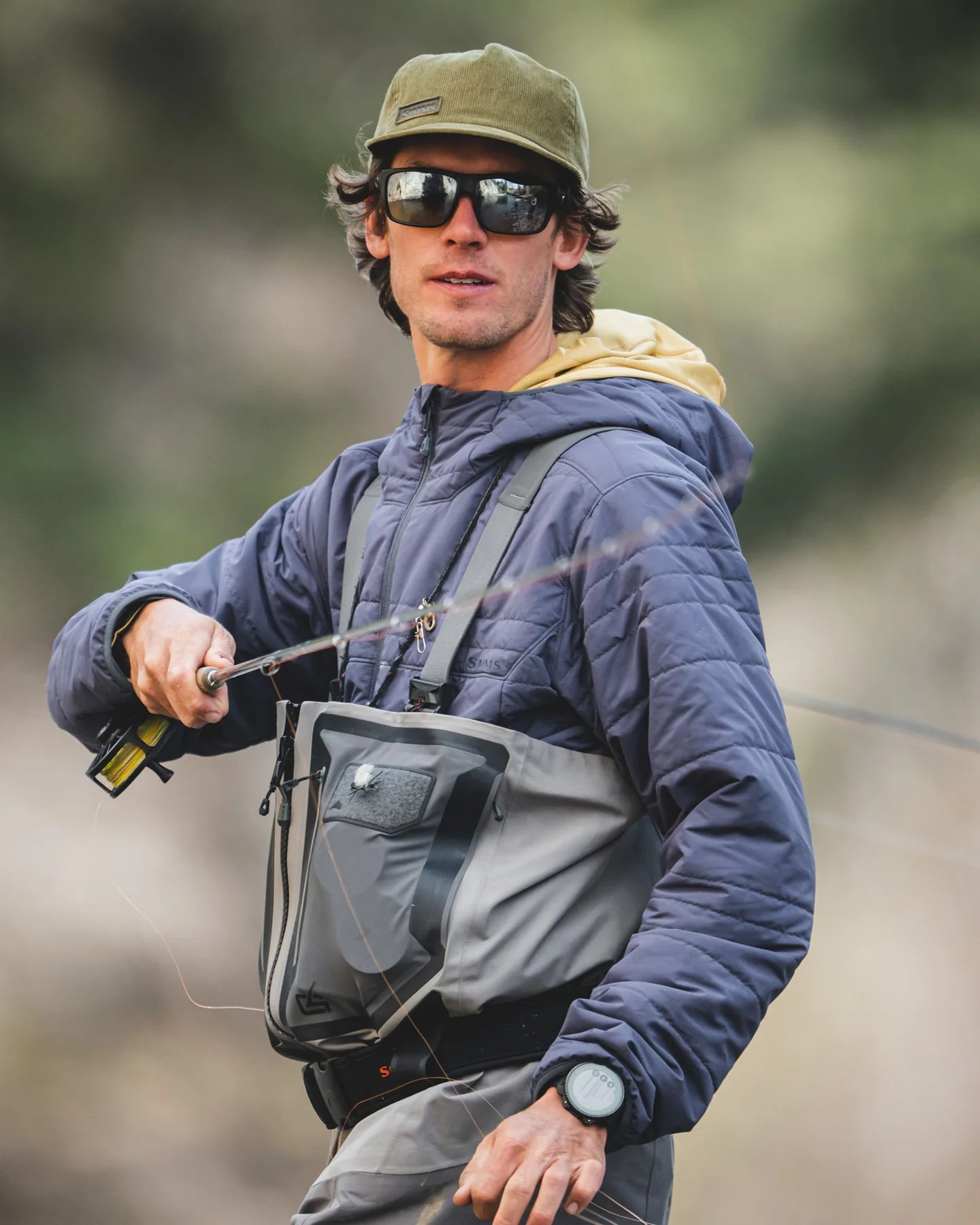 Simms Fall Run Insulated Hoody worn fly fishing in waders for cold weather river fishing