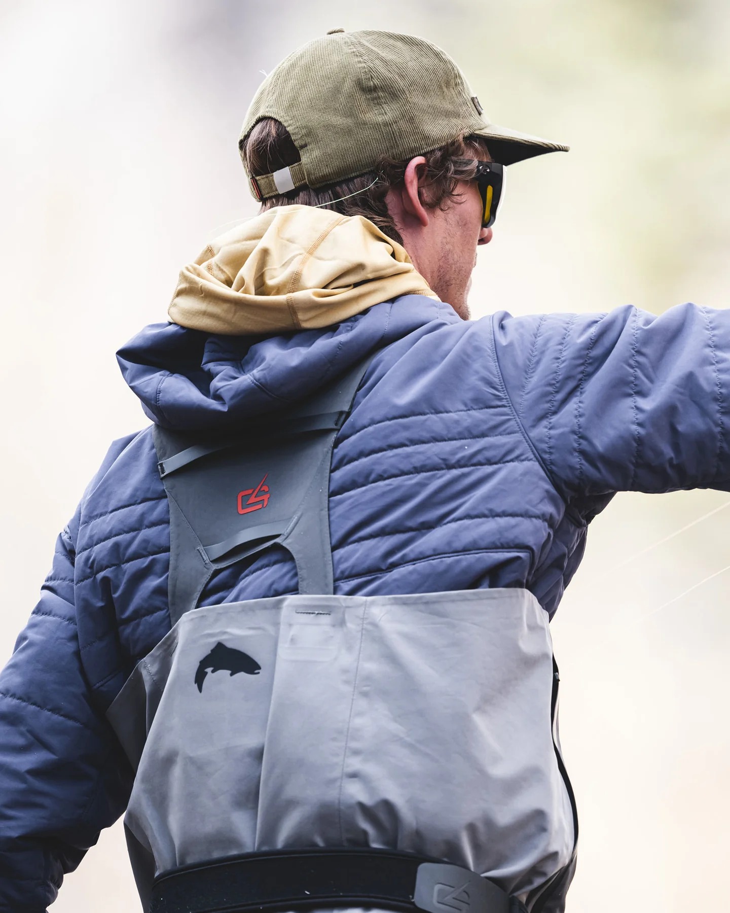 Simms Fall Run Insulated Hoody layered with fishing waders for cold weather fly fishing