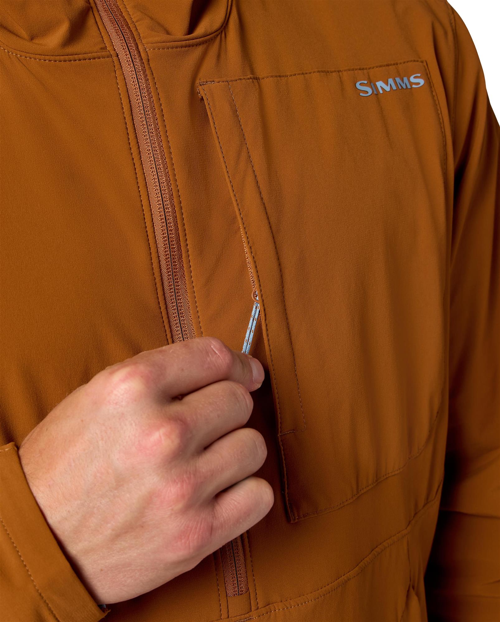 Simms Rogue Flex chest pocket detail with YKK zipper, secure storage on fishing pullover