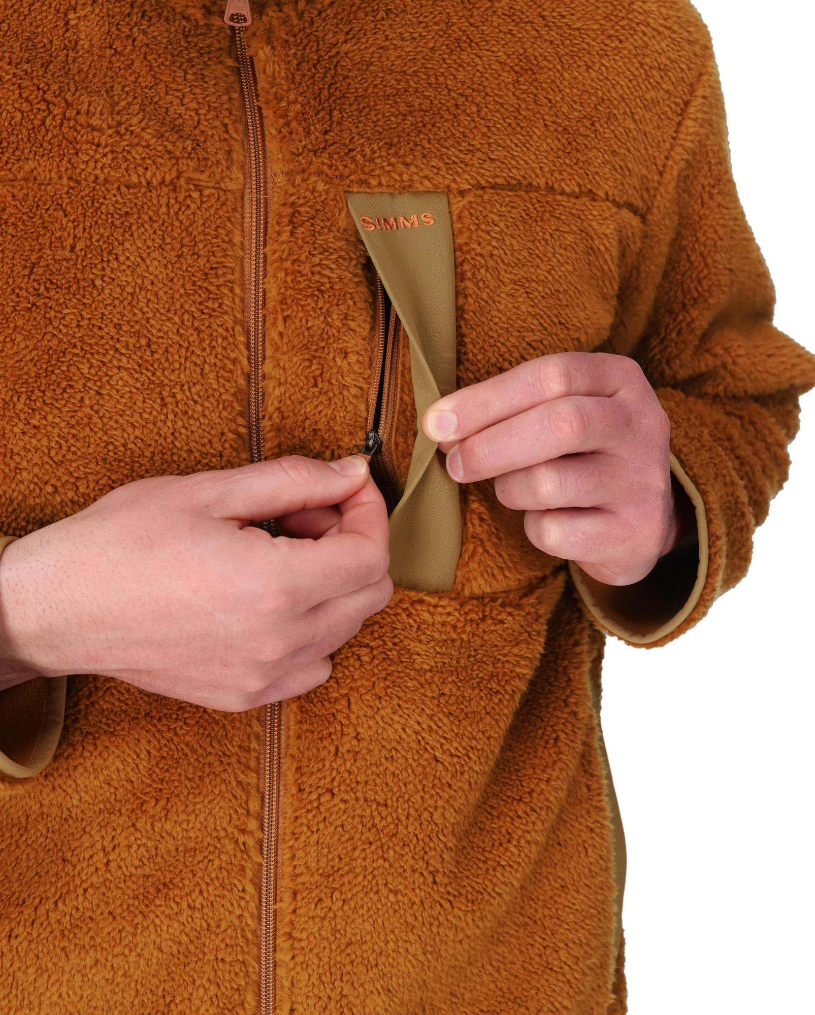 Close-up of Simms Coldweather Fleece chest pocket with zipper detail