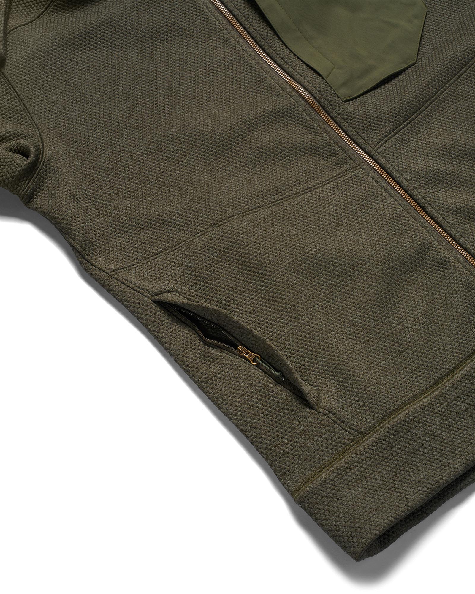 1. Simms Harbor Fleece full-zip fishing jacket detail showing a recessed hand pocket zipper for secure storage