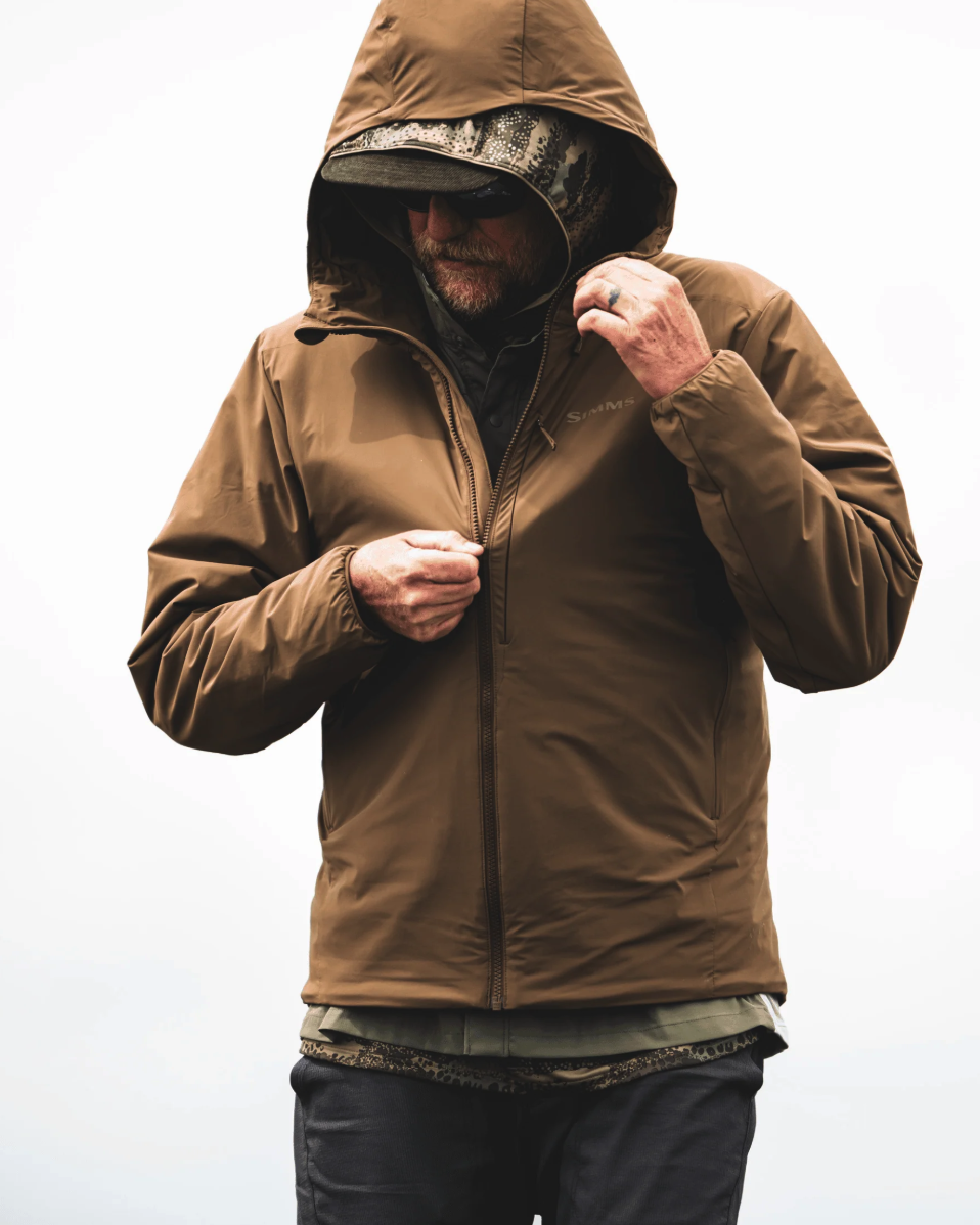 Man zipping up Simms Midstream Hooded Jacket