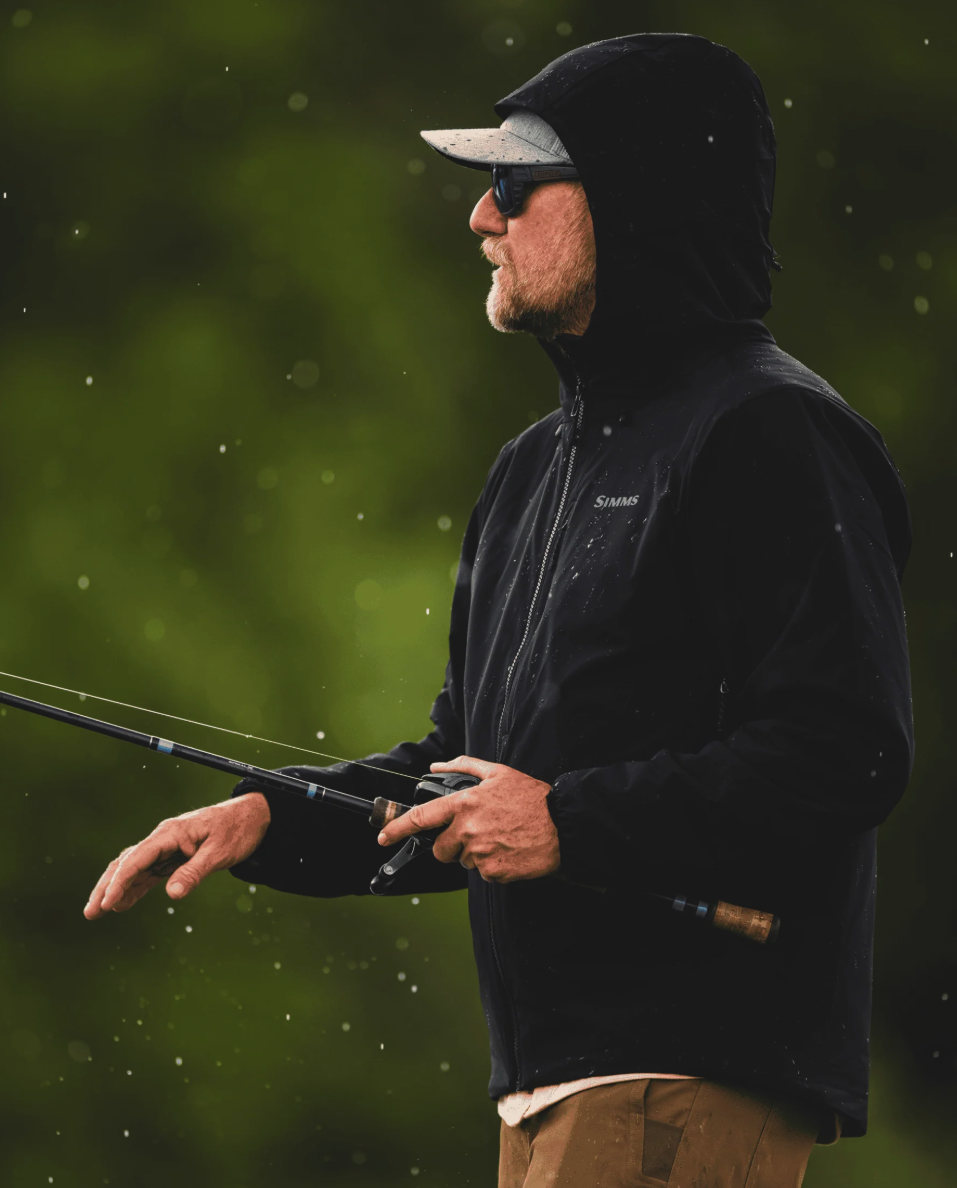 Angler fishing with Simms Midstream Hooded Jacket