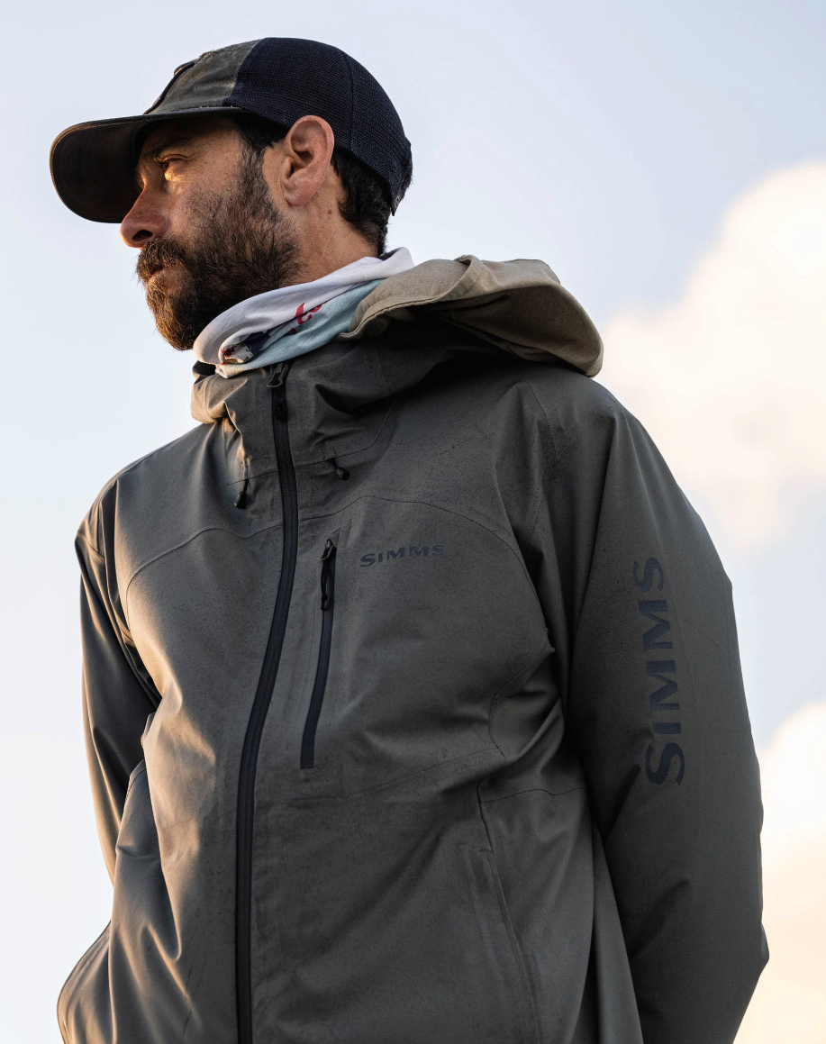 Up view of angler looking at water wearing Simms Vapor Elite Jacket
