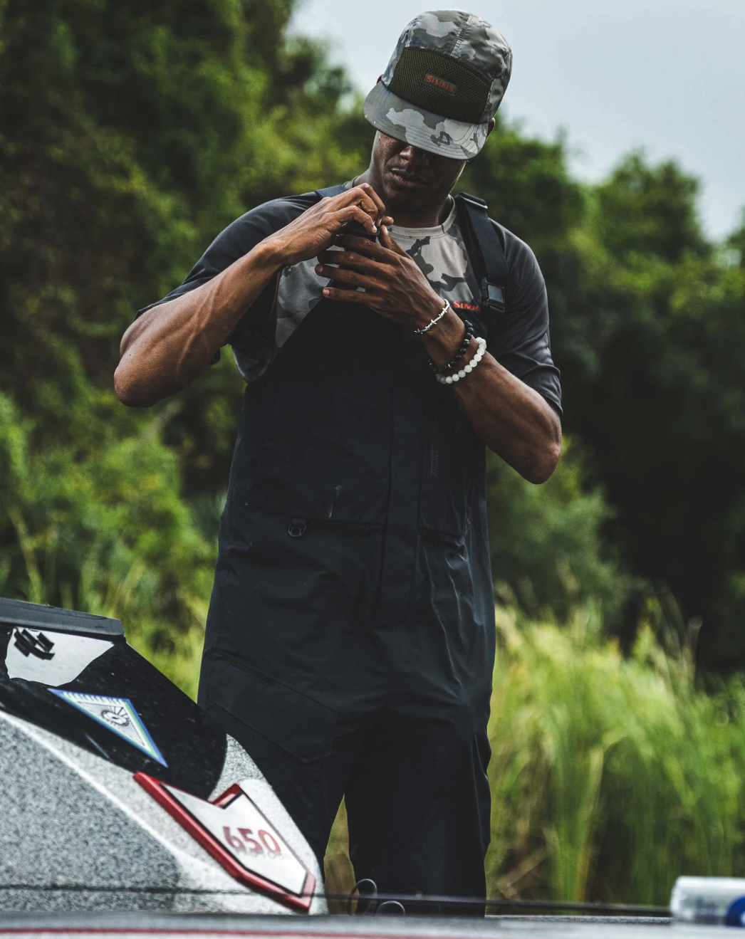 Simms Challenger Fishing Bibs with reinforced knees for durability on the water.