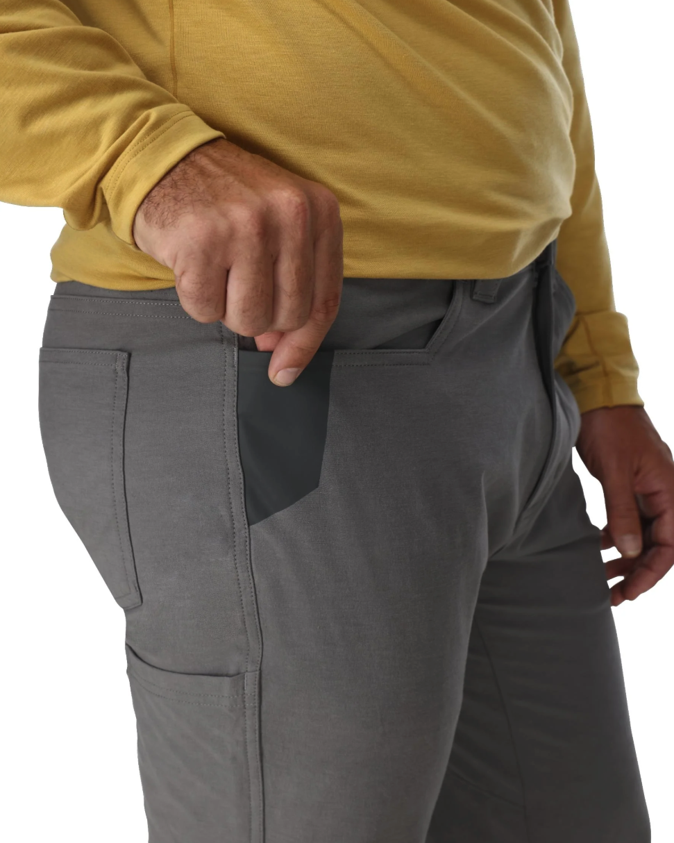 Knife pocket detail on model wearing Simms Challenger Pant.