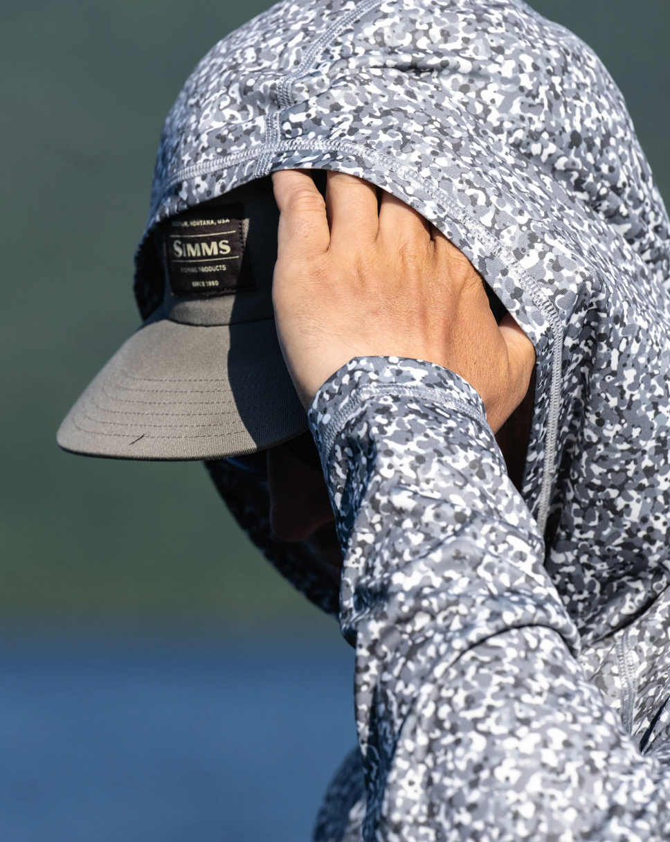 Man with hood up wearing Simms Challenger Solar Hoody