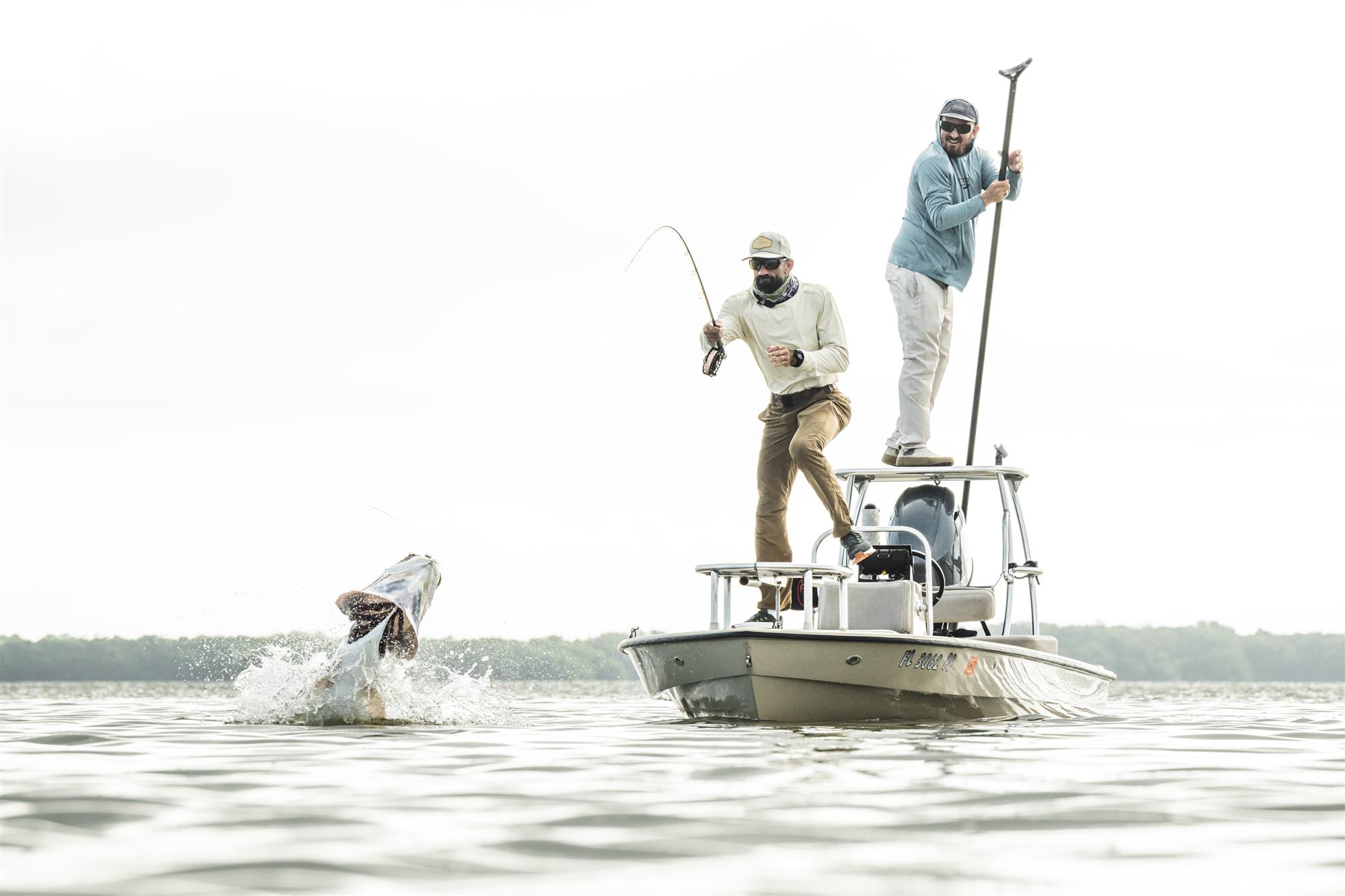Simms Artist Series Tech Hoody action shot fishing from skiff in sun protection hoody